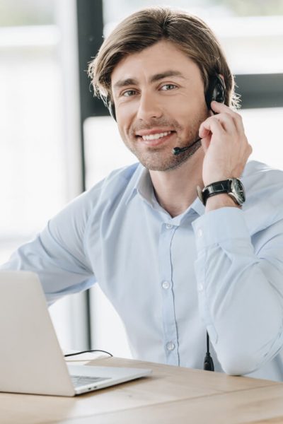 smiling-call-center-worker-with-laptop-looking-at-2021-08-29-22-51-33-utc.jpg